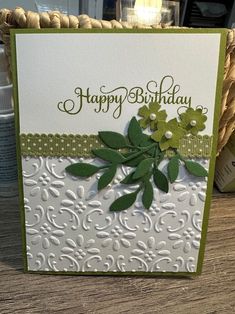 a close up of a birthday card on a table with a basket in the background