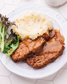 meatloaf with mashed potatoes, gravy and broccoli on a plate