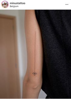 a person's arm with a small tattoo on the left side of their arm