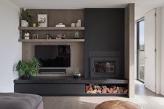 a living room with a fireplace and shelves on the wall, along with a couch