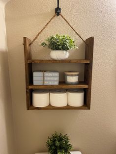 a bathroom with a toilet and shelf above it