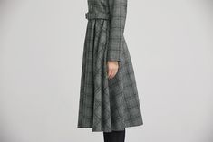 "Simple. With its pleated skirt and grayscale plaid pattern, this vintage wool dress epitomizes classic styling. She's all class and quality with no bells or whistles. Near-perfect vintage condition, designed with lapel collar, long sleeves and tie belt waist, it will be your favorite one of your wardrobe. Details: * 35% wool blend, 35% fiber and polyester, 30% nylon * Polyester lining * long sleeves * tie belt waist * lapel collar * button decoration in front * knee length * back zipper closure Elegant Midi-length Plaid Dress, Elegant Plaid Dress For Work, Classic Fitted Plaid Dress For Fall, Classic Plaid Dress For Work In Fall, Elegant Plaid Dress For Workwear In Fall, Elegant Fall Plaid Midi Dress, Chic Plaid Winter Dress, Elegant Plaid Midi Dress For Fall, Elegant Midi-length Plaid Dress For Fall