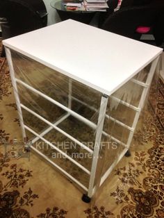 a white table sitting on top of a carpet covered floor