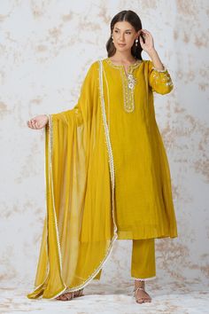 Mustard yellow floral embroidered A line kurta in cutdana and sequin work. Paired with lace hem pant and dupatta. Comes with rayon slip.
Component: 4
Pattern: Embroidered
Type Of Work: Zardozi work, Cutdana work, Bead work, Sequins
Neckline: Round notched
Sleeve Type: Three quarter
Fabric: Chanderi 40grm, Georgette, Glace Cotton, Rayon
Color: Yellow
Other Details: 
Embroidered dupatta
Bead tassel sleeve hem
Occasion: Sangeet - Aza Fashions Latest Dress Design, Kurta Style, A Line Kurta, Smart Outfit, How To Hem Pants, Pernia Pop Up Shop, Lace Hem, Yellow Fabric, Kurta Set