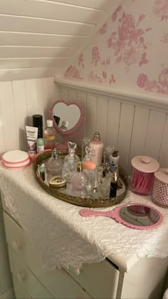 a vanity with pink and white accessories on it