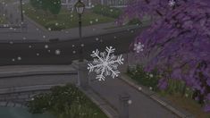 a snowflake that is sitting on the ground next to a lamp post and some trees