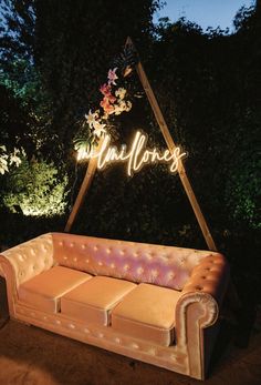 a couch sitting in front of a sign that says happiness