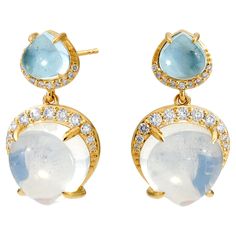 Created in 18 karat yellow gold Blue topaz 3 carats approx. Moon quartz 11.50 carats approx. Diamonds 0.40 carat approx. 18kyg butterfly backs Limited edition Luxuriate in the unparalleled charm of our Cosmic Gemstone Dangle Earrings. Expertly crafted in 18 karat yellow gold, these earrings feature an enchanting combination of blue topaz, moon quartz, and diamond gems, each providing an exquisite 3 carats, 11.50 carats, and 0.40 carats respectively. Finished with 18kyg butterfly backs, these lim Moon Quartz, Topaz Yellow, Earrings With Diamonds, Contemporary Earrings, Quartz Earrings, Blue Moon, Blue Topaz, Beautiful Jewelry, Topaz