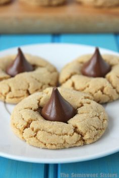 three peanut butter cookies with chocolate frosting on a white plate