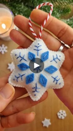 someone holding a snowflake ornament in their hand