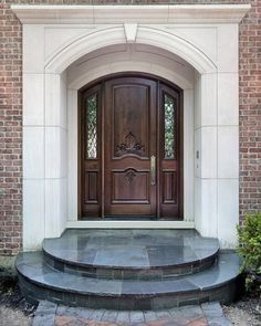 two planters are on the steps in front of a door