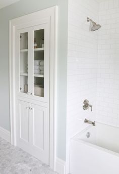 a bathroom with white walls and tile flooring