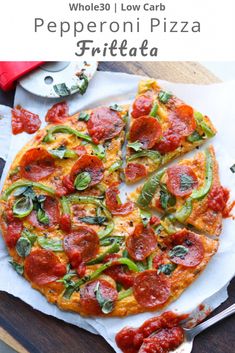 a pizza sitting on top of a wooden cutting board next to a knife and fork