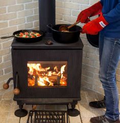 a person standing in front of a stove cooking food