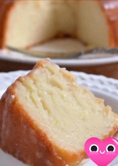 a piece of cake on a white plate with a pink heart in the middle and a slice missing from it