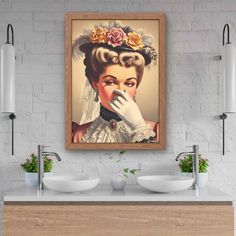 a bathroom with two sinks and a painting on the wall above it's counter