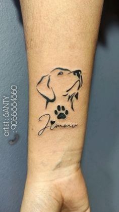 a dog's paw and name tattoo on the left inner arm, with an image of a dog