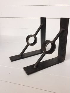 a pair of metal bookends sitting on top of a white table