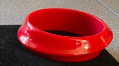 Red plastic bangle bracelet Priced at $55 Red Plastic Bracelet Jewelry, Modern Red Bangle Bracelets, Modern Red Bangle Bracelet, Plastic Bangles, Bangle Bracelet, Favorite Jewelry, Cuff Bracelets, Bangle Bracelets, Jewelry Bracelets