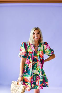 Get ready to turn heads in the Mitzi Print Mini Dress! This playful dress features a tropical floral print in bright, vibrant colors that will make you stand out in any crowd. With beaded buttons and a puff sleeve, this cotton poplin dress is perfect for a day out on the town. Product Details: Measurements: BUST small 19" medium 20" large 21" LENGTH small 35" medium 36" large 37" cotton poplin beaded buttons puff sleeve flowy fit model wearing size small model stats: size 4, 5'5 Cotton Dress With Vibrant Print For Vacation, Tropical Multicolor Dress For Day Out, Vacation Dress With Bold Print And Short Sleeves, Short Sleeve Dress With Bold Print For Vacation, Tropical Multicolor Mini Dress For Vacation, Multicolor Floral Print Mini Dress With Puff Sleeves, Playful Floral Print Vacation Dresses, Green Fruit Print Dresses For Spring, Tropical Dress With Vibrant Print For Day Out