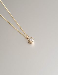 DETAILS * We never use gold plates or gold-filled metals in any of our jewelry. All the metals we use are lead-free, nickel-free, and hypoallergenic. * 0.03 ct Solitaire Pendant Width: 2.5 mm * 0.03 ct Solitaire Pendant Height: 2.5 mm * Chain Length: 18 inches * Chain Type: Dainty Cable * Clasp: Spring Ring * Ready to Ship in 1-3 Business Days * 100% US sourced * 6 Months Warranty * Free returns within 30 days from the order date DIAMOND DETAILS * Gem Stone: Genuine Diamond * Diamond-Cut: Round * Diamond Carat Weight: 0.03 CT - 0.06 CT - 0.15 CT * Diamond Color-Clarity: H Color, SI Clarity * Setting Type: Bezel Setting * 100% US sourced HANDMADE * Handcrafted by our trusted craftsmen with care. * 100% Ethically Sourced. * All processing of the packaging is done by hand.  * The Preparation Minimalist 14k Gold Diamond Necklace With Bezel Setting, Everyday Gold Jewelry With Single Cut Diamonds, Gold 14k Diamond Necklace With Single Diamond, Gold Birthstone Necklace With Bezel Setting, Gold Minimalist Birthstone Necklace With Bezel Setting, Everyday Gold Birthstone Necklace With Bezel Setting, Classic Gold Birthstone Necklace With Round Stone, Gold Jewelry With Bezel Setting In Recycled Gold, Minimalist Jewelry With Bezel Setting In Recycled Gold