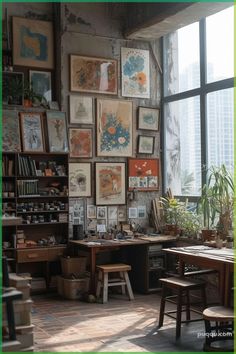 a room filled with lots of framed pictures on the wall next to a table and chairs