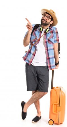 a man is standing with his luggage and making the peace sign