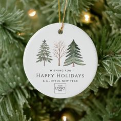 a christmas ornament hanging on a tree with the words wishing you happy holidays and a joyful new year