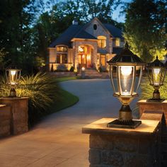 two lamps are lit up in front of a house