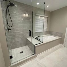 a bathroom with a walk in shower next to a bath tub