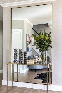 a living room with a large mirror on the wall