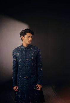 Blue Sapphire Sherwani | Jatin Malik Elevate your style with our space blue Jamawar embroidered contemporary sherwani set. Paired effortlessly with matching side pleated kurta and tapered trousers, this ensemble exudes modern sophistication and timeless elegance, perfect for any special occasion. Included in purchase: Sherwani, kurta, trousers Product Specification Color: Space Blue Fabric: Linen Silk Occasion: Engagement, Wedding, Bridal, Reception Style: Sherwani, Kurta, trousers Care: Dry Clean Work: Hand Embroidery Customization options:Can be customized in any color or style Note: A stylist will contact you to confirm measurements after your order is placed.Estimated delivery time: 4 -6 weeks (Variation in color, fabric & detail is possible. Model images are only representative.) This Designer Blue Bandhgala, Designer Semi-formal Kurta With Resham Embroidery, Designer Embroidered Semi-formal Kurta, Designer Unstitched Blue Sherwani, Blue Bandhgala With Naqshi For Formal Occasions, Formal Blue Sherwani With Naqshi Detailing, Formal Blue Sherwani With Naqshi, Designer Blue Kurta For Formal Occasions, Blue Sherwani With Naqshi Long Sleeve