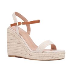 A summer style essential, the Unita espadrille sandal features platform wedge heels that provide both height and comfort. Contrasting ankle straps add a distinctive touch to the design, while polished buckle closures enhance the sandal's sophisticated appeal. Perfect for pairing with sundresses, shorts, or skirts, the Unita sandal effortlessly combines chic style with practicality. Elevate your warm-weather wardrobe with this versatile espadrille, ideal for adding a touch of elegance and ease to Adjustable Ankle Strap Wedge Sandals For Summer, Trendy Espadrille High Heels, Trendy Summer Espadrille Heels, Spring Espadrille Wedge Heels, Adjustable Summer Wedge Heels, Espadrille Wedge Heels For Spring, Trendy Espadrille Wedge Heels, Espadrille High Heels For Summer, High Heel Espadrilles For Vacation