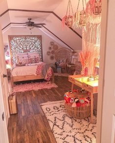 a bedroom with a bed, desk and chandelier hanging from it's ceiling