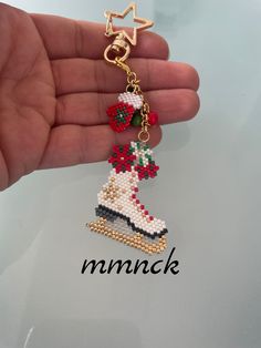 a hand holding a beaded christmas ornament