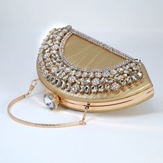 New to our Millennium collection, This beautiful romantic Half Moon Rhinestones bridal clutch bag is made of very fine quality Polyester Fabric, metal, Rhinestone and it comes with a 45 inch long Detachable chain for your Big day! Measurements- the clutch is 5 inches Height, 9 inches length and 2.5 inches in width ► ABOUT YOUR ORDER * All items are neatly packaged in our beautiful jewelry boxes and elegant organza bags. * All items are 100% gift-ready. * Each order comes with a personalized hand Gold Evening Bag With Pearl Handle For Reception, Glamorous Handheld Clutch For Wedding, Elegant Evening Bag With Pearl Handle For Receptions, Gold Clutch Shoulder Bag For Wedding, Glamorous Clutch Bag For Reception, Elegant Handheld Evening Bag For Reception, Glamorous Clutch For Reception, Glamorous Rhinestone Shoulder Bag For Weddings, Glamorous Gold Shoulder Bag For Wedding