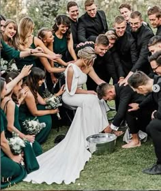 a bride and groom are surrounded by their wedding party