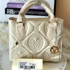 Off White Creamy Ivory Hand Bag With Removable Crossbody Strap Features Gold Hardware Button Closure Quality Vegan Leather New With Tags Retail $299 8" Tall Not Including Straps 9" Long 4.5" Wide Luxury Cream Cotton Bags, Luxury Embellished Cream Bag, High-end Cream Bags With Detachable Handle, High-end Cream Shoulder Bag With Detachable Handle, White Valentino Bag, Italian Leather Purse, Valentino Crossbody, Expensive Bag, Red Studs