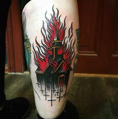 a man's leg with a tattoo on it that has flames coming out of it