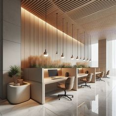 an empty office with several desks and plants on the wall, along with hanging lights