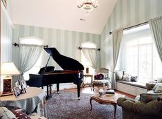 a living room filled with furniture and a grand piano