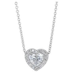 Lovely 1.22ct Diamonds Heart-Shaped Halo Necklace in 18k White Gold - GIA Certified Dazzle with sophistication and charm wearing this exquisite diamond halo necklace. Crafted in luxurious 18k white gold, the centerpiece boasts a stunning 1.00-carat heart-shaped diamond, radiating unmatched brilliance. Complementing this are 20 round side diamonds totaling 0.22-carat, adding a brilliant touch to this elegant piece. Certified by GIA, this necklace assures superior quality and exceptional craftsman Halo Necklace, Heart Shaped Diamond, Diamond Heart, Halo Diamond, Chain Lengths, Diamond White, Jewelry Necklace Pendant, Halo, Heart Shapes