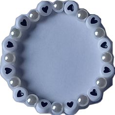 a white and black heart shaped plate with hearts on it's sides, in the shape of a circle