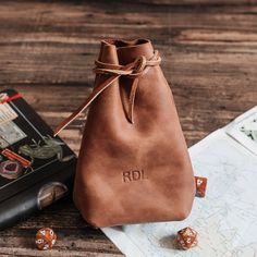 Elevate your gaming experience with our personalized leather dice bag. This handcrafted medieval-style pouch, complete with genuine leather drawstring and cord ends, is the perfect storage solution for your dice, jewelry, or small treasures. Whether it's a birthday, anniversary, or Christmas, this unique custom gift is sure to delight gamers and fantasy enthusiasts. Level up your gifting game today! PRODUCT FEATURES: ✔ Wide range of colors in our extensive leather color palette (please refer to the listing photo). ✔ Crafted with high-quality genuine leather for durability and timeless style. ✔ Each item is lovingly handmade, showcasing skilled craftsmanship. ✔ Comes in gift packaging of a wool bag, adding an elegant touch. ✔ Every customer receives a leather keychain as a token of apprecia Medieval Handmade Pouch For Gift, Medieval Style Handmade Pouch For Gift, Medieval Handmade Pouch As Gift, Gift Leather Pouch With Case Included, Leather Pouch With Case Included For Gift, Personalized Brown Bag For Gift, Soft Leather Bags For Gifts, Personalized Brown Leather Bag, Brown Soft Leather Pouch For Gifts