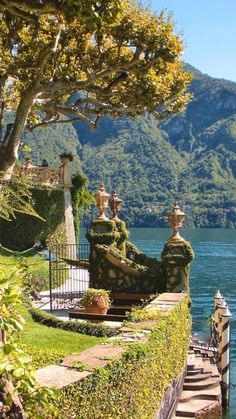 a scenic view of the water and mountains from an outdoor area with steps leading up to it