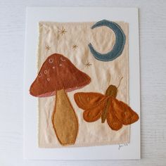 a card with an image of two butterflies and a mushroom on it's side