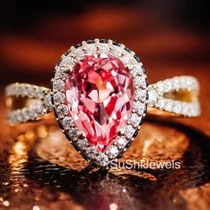 a pink diamond ring with white diamonds around it