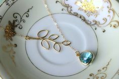 READY TO SHIP! Aquamarine Lariat Necklace Aqua Blue Lariat Leaf Gold Necklace - Bridal Necklace - Bridesmaid Lariat Necklace - Bridesmaid Jewelry WeddingThe aquamarine gem is 13mm with 5mm thickness at the widest part. It is 14k gold plated. The chain is 14k gold filled and measures 2mm X 1.4mm. It is a flat cable design. The length of this particular necklace is approximately 16.5 inches. The leaf measures 18mm x 39mm. If you need a different length, no problem! Please just let me know when you Elegant Blue Lariat Necklace Gift, Elegant Blue Lariat Necklace With Adjustable Chain, Dainty Blue Necklace For Wedding, Delicate Blue Necklace For Wedding, Aquamarine Gem, Necklace Bridal, Jewelry Wedding, Lariat Necklace, Bridal Necklace