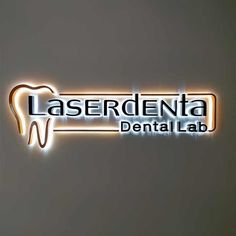 the logo for laserdenta dental lab, which is lit up with neon lights