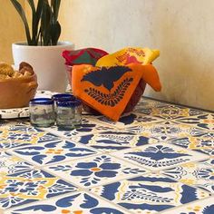 a table topped with lots of food next to a potted plant